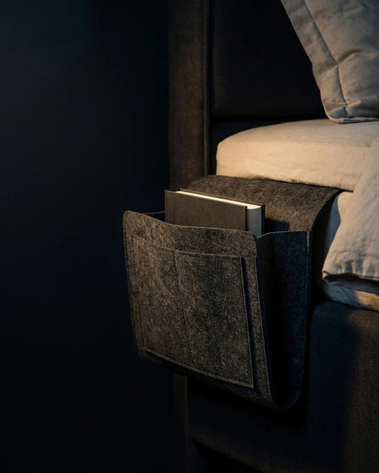 Grey Felt Bedside Caddy hanging beside a bed