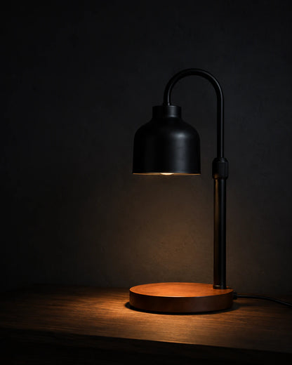 Black Nordic candle warmer lamp isolated against a dark background